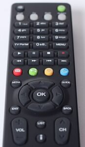 Living room with smart TV playing a video and nearby devices showing media files for local playback