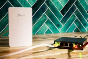 Living-room streaming setup showing a streaming stick with Ethernet cable connected to a router and a separate Wi‑Fi symbol above a TV.