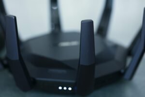 Home Wi‑Fi router sending colored streams to TV, laptop and game console to illustrate prioritizing video traffic