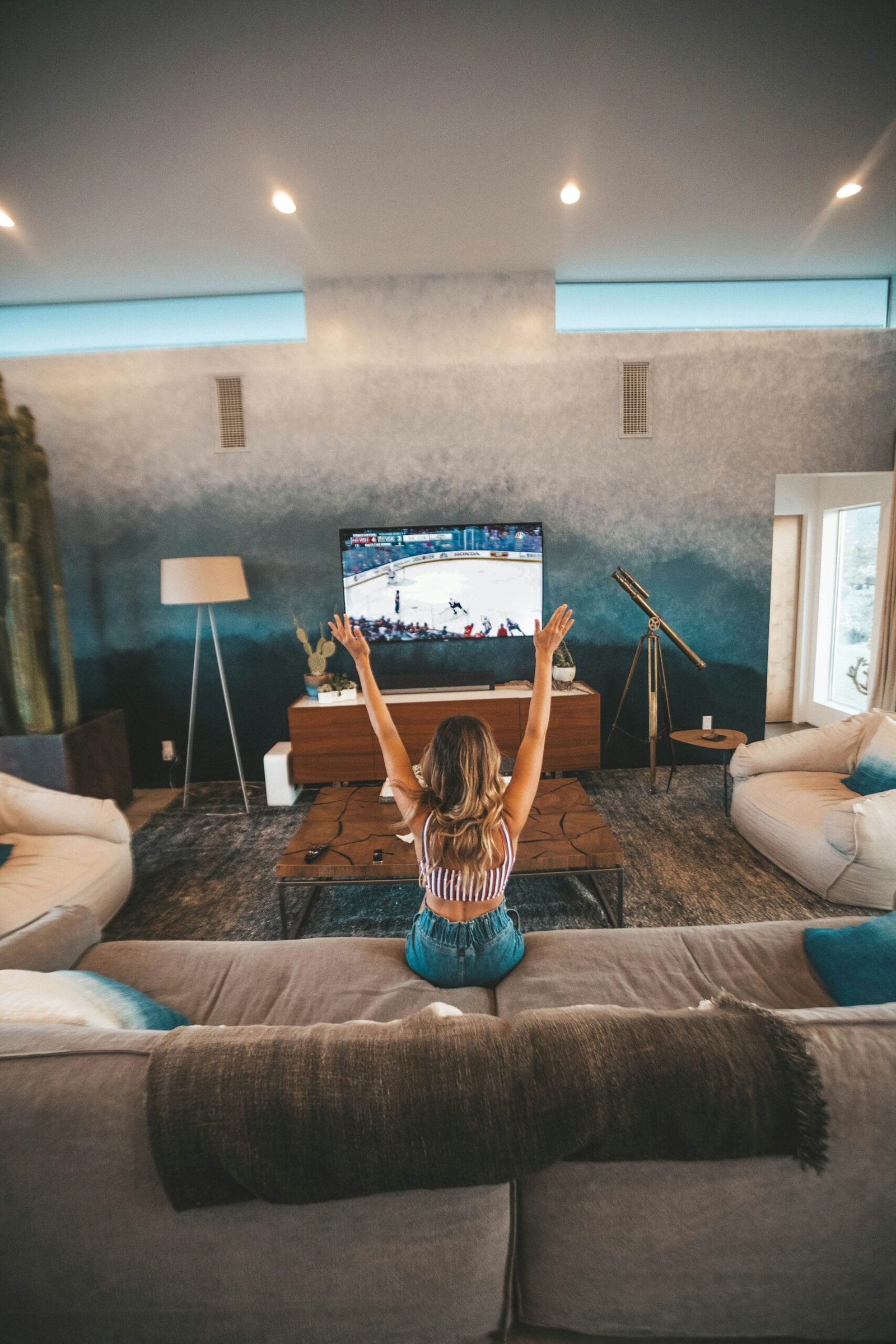 Notebook, tablet and printed episode checklist on a living-room coffee table for planning a series rewatch