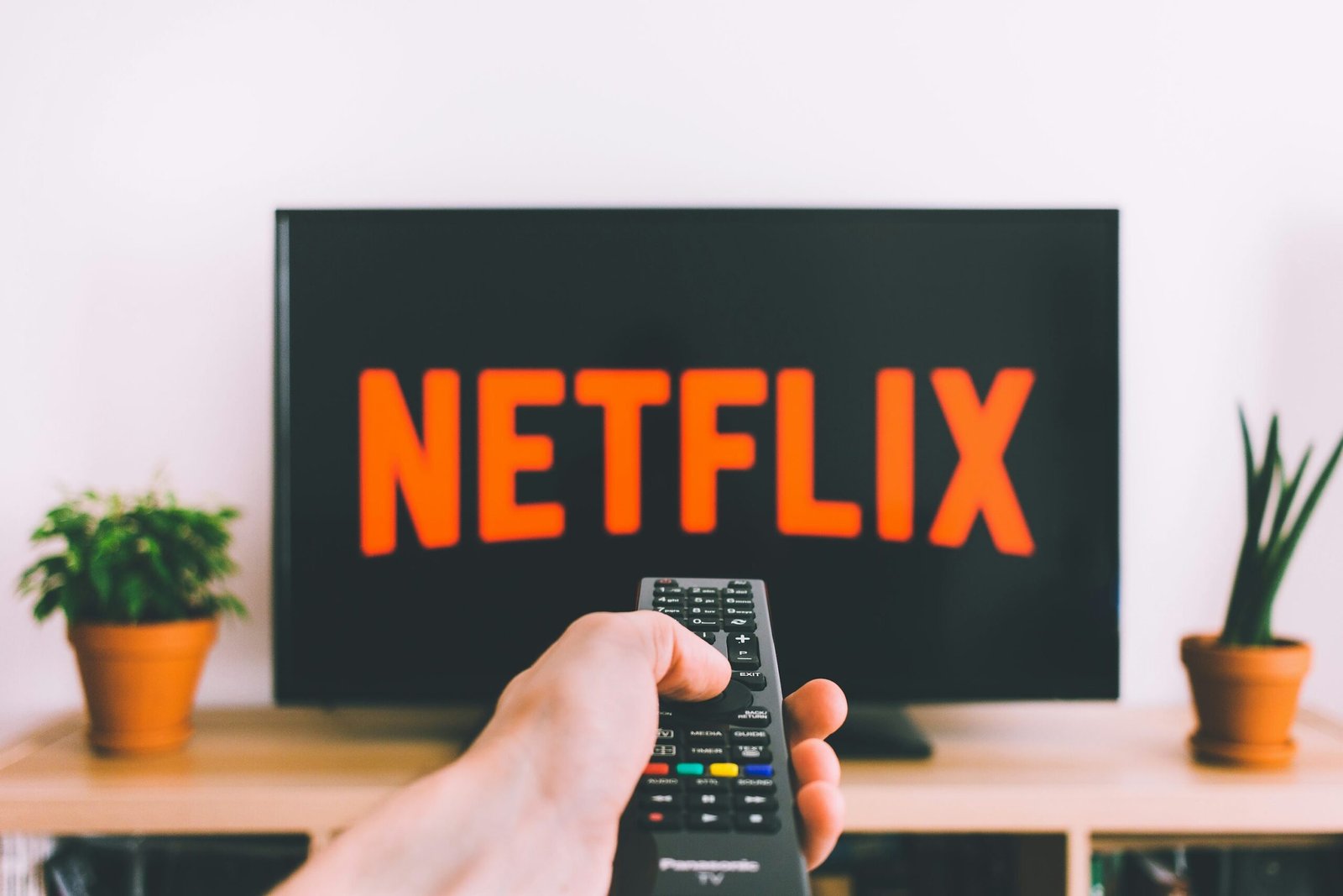 Family on a couch choosing separate TV series profiles on a streaming menu