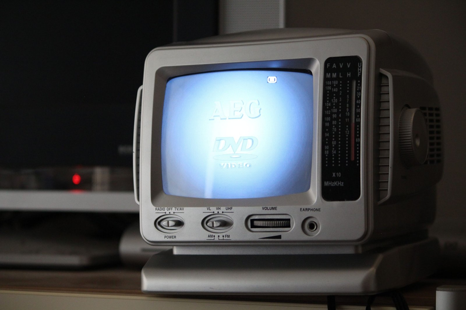 Connected TV in a living room with abstract overlays representing data signals such as device info, contextual cues, and anonymous audience segments.