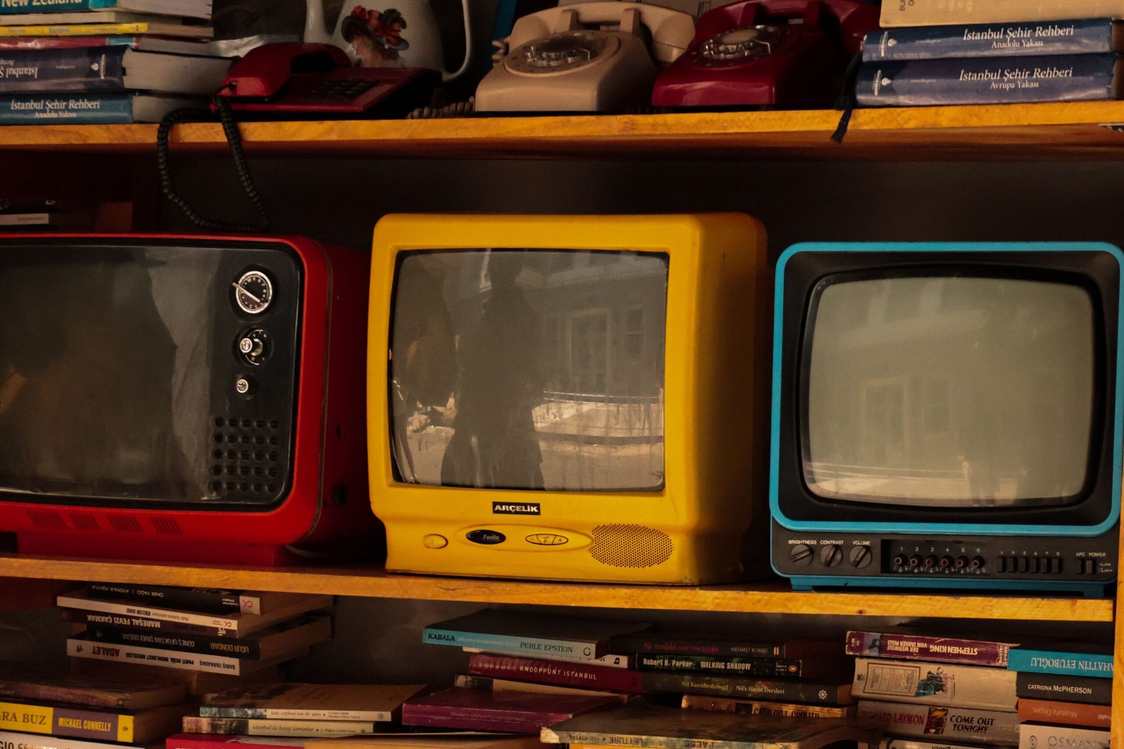 Split image of a TV with marketing text on one side and a magnifying glass inspecting technical notes on the other.