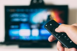 Hand holding remote control for a streaming app